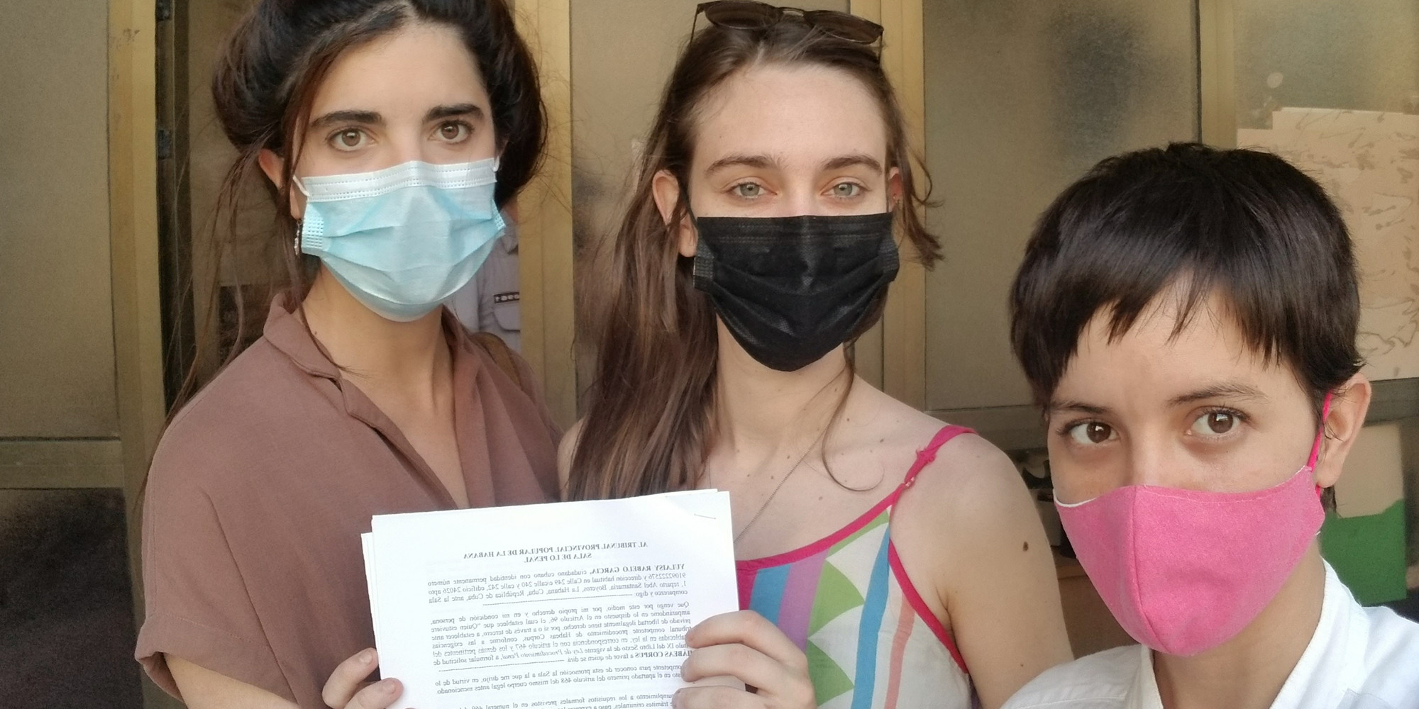 Carolina Barrero, Camila Ramírez Lobón, and Juliana Rabelo with a petition demanding an end to the harassment and detainment of Cuban artists. Photo courtesy of Juliana Rabelo