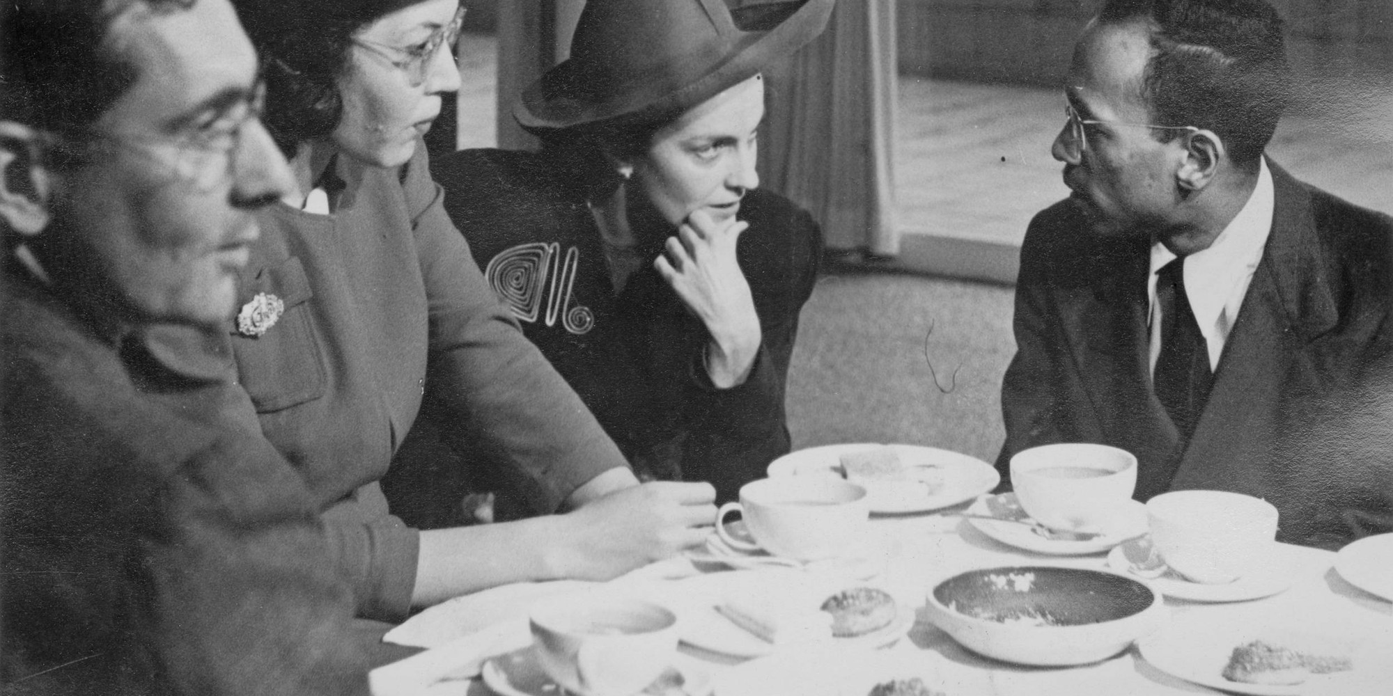 Guests at a preview of the exhibition Young Negro Art, The Museum of Modern Art, New York, 1943. From left: MoMA director Alfred H. Barr Jr., Elizabeth Catlett, associate curator of Painting and Sculpture Dorothy Miller, Charles White