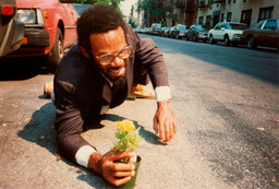 Pope.L. How Much is that Nigger in the Window a.k.a. Tompkins Square Crawl. 1991. Five inkjet prints; Timberland leather boots; asphalt. Acquired in part through the generosity of Jill and Peter Kraus, Anne and Joel S. Ehrenkranz, The Contemporary Arts Council of The Museum of Modern Art, The Jill and Peter Kraus Media and Performance Acquisition Fund, and Jill and Peter Kraus in honor of Michael Lynne. © 2019 Pope.L. Courtesy of the artist.