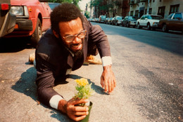 Pope.L. How Much is that Nigger in the Window a.k.a. Tompkins Square Crawl. 1991. Five inkjet prints; Timberland leather boots; asphalt. Acquired in part through the generosity of Jill and Peter Kraus, Anne and Joel S. Ehrenkranz, The Contemporary Arts Council of The Museum of Modern Art, The Jill and Peter Kraus Media and Performance Acquisition Fund, and Jill and Peter Kraus in honor of Michael Lynne. © 2019 Pope.L. Courtesy of the artist.