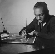 Jacob Lawrence with a panel from the Frederick Douglass series, c. 1939. Harmon Foundation Collection, National Archives and Records Administration, College Park, Md.