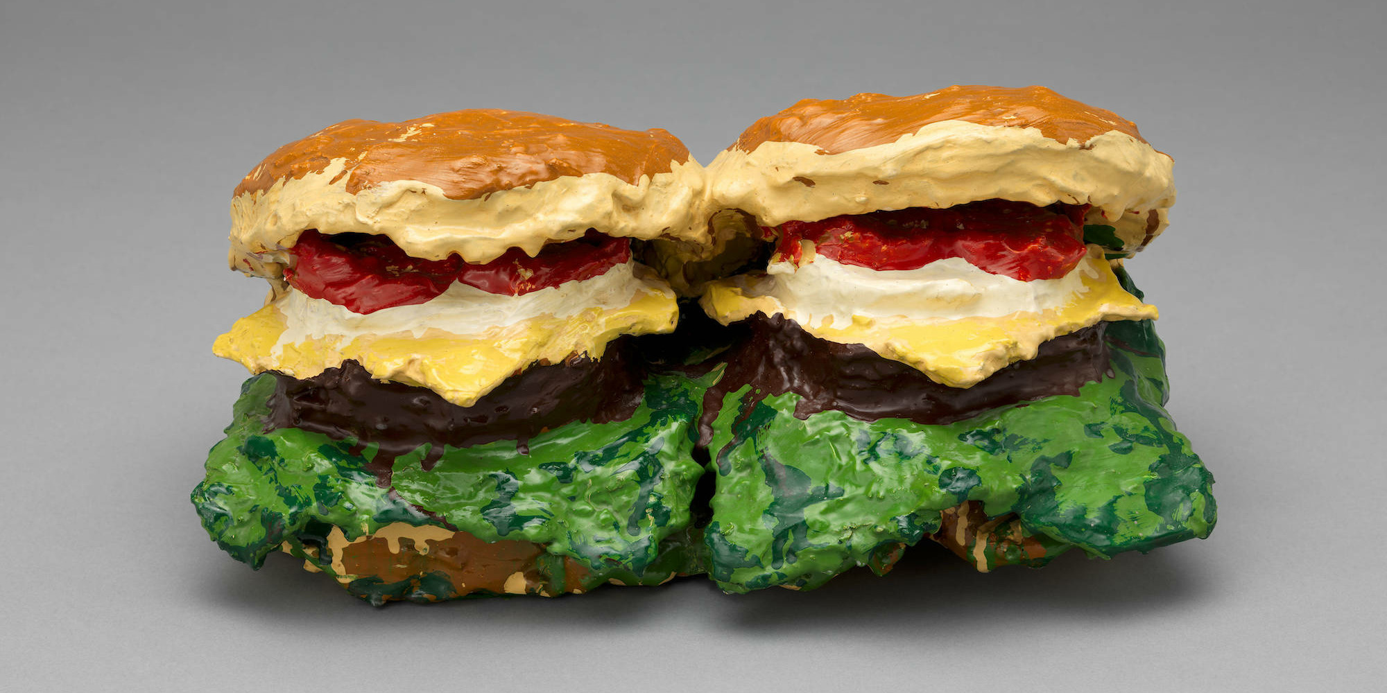 Claes Oldenburg. Two Cheeseburgers, with Everything (Dual Hamburgers). 1962. Burlap soaked in plaster, painted with enamel, 7 × 14 3/4 × 8 5/8&#34; (17.8 × 37.5 × 21.8 cm). The Museum of Modern Art, New York. Philip Johnson Fund. © 2022 Claes Oldenburg