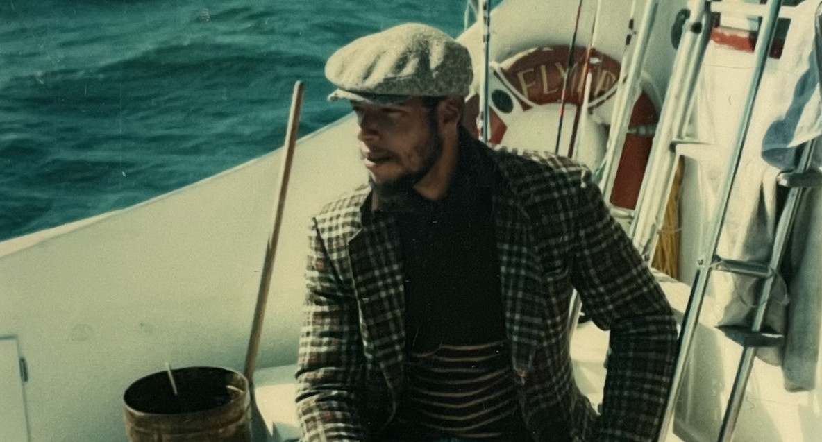 Brad Johnson aboard a blue fishing boat, 1984