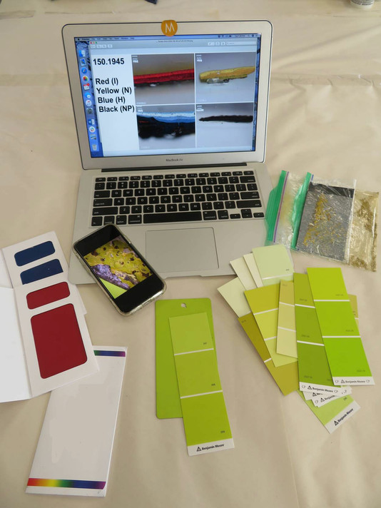 Comparing paint coupons to cross-sections of samples from the sculpture. Photo: Abigail Mack