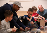 Image of the family program &#34;Explore This! Activity Stations”. 2019. Digital Image © The Museum of Modern Art, New York. New York Photo: Manuel Martagon Image description: Participants engaged in an activity during a Family Gallery Talk.