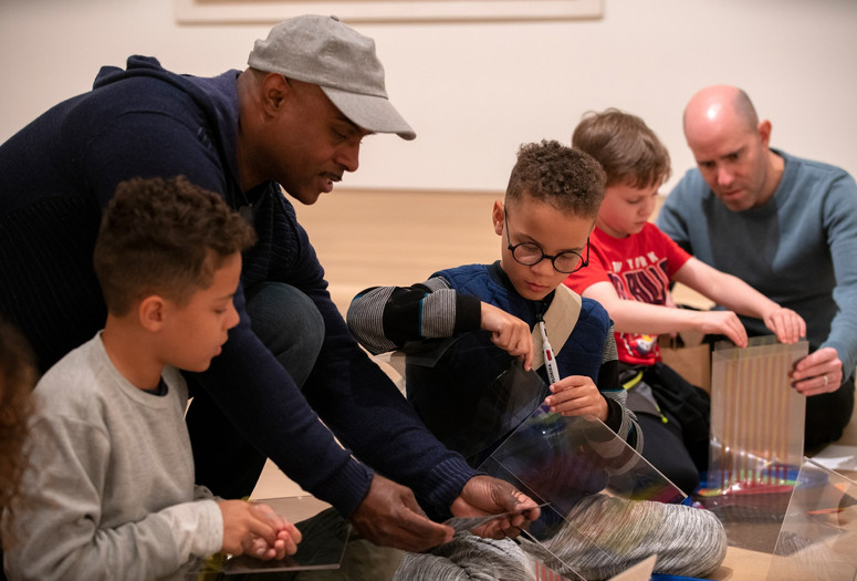 Image of the family program "Explore This! Activity Stations”. 2019. Digital Image © The Museum of Modern Art, New York. New York Photo: Manuel Martagon Image description: Participants engaged in an activity during a Family Gallery Talk.