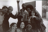 Clockwise from top left: Andy Owens, Linda Goode Bryant, David Hammons, Lowery Stokes Sims, Cheryl Mason Dorman, Faythe Weaver, Florence Harding, and Roberta Wolfe Bryant, with Elizabeth Catlett’s Homage to My Young Black Sisters (1968) before the opening of the exhibition Synthesis, Just Above Midtown, Fifty-Seventh Street, 1974. Courtesy Faythe Weaver, New York