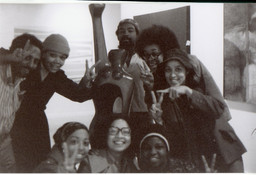 Clockwise from top left: Andy Owens, Linda Goode Bryant, David Hammons, Lowery Stokes Sims, Cheryl Mason Dorman, Faythe Weaver, Florence Harding, and Roberta Wolfe Bryant, with Elizabeth Catlett’s Homage to My Young Black Sisters (1968) before the opening of the exhibition Synthesis, Just Above Midtown, Fifty-Seventh Street, 1974. Courtesy Faythe Weaver, New York