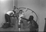 Still from video footage in the JAM Records featuring Randy Williams, Marquita Pool-Eckert, and David Hammons with Jorge Luis Rodriguez’s Circulo con cuatro esquinas (Circle with Four Corners) (1976), in Rodriguez’s exhibition Recent Sculpture, Just Above Midtown, Fifty-Seventh Street, 1976. Collection Linda Goode Bryant, New York