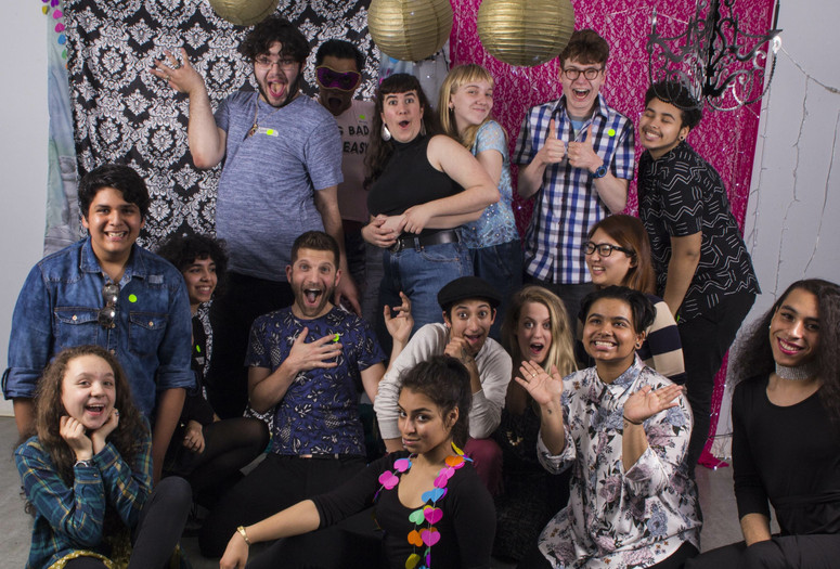 Open Art Space teens and teaching artists pose before a backdrop smiling at the camera. Photo: Néstor Pérez-Molière