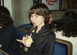 Portrait of Aimee France. Photo: Parker Hao. Courtesy of the Artist Image Description: Artist and Baker Aimee France sits in a restaurant booth holding a seltzer while smiling at the camera.