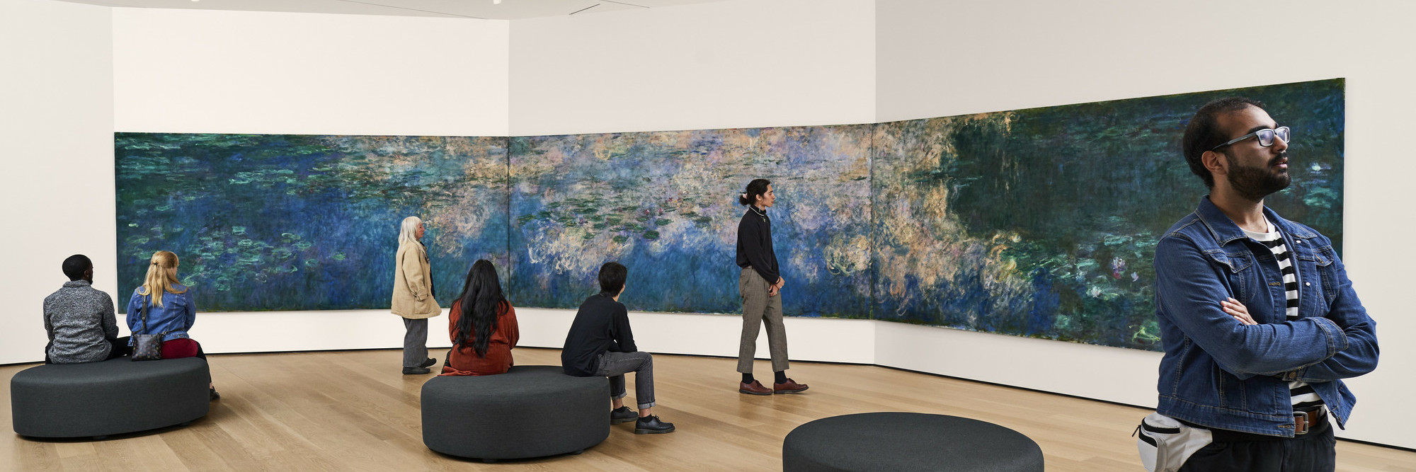 A view of the fifth-floor collection galleries. Shown: Claude Monet. Water Lilies. 1914–26. Oil on canvas, three panels. Mrs. Simon Guggenheim Fund. © 2022 The Museum of Modern Art, New York. Photo: Noah Kalina