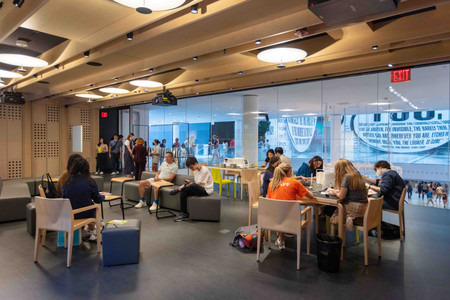 Photo of people sitting at tables in the Creativity Lab. The Museum of Modern Art, New York. Photo: Beatriz Meseguer/onwhitewalls.com. Digital image ©️ 2022 The Museum of Modern Art, New York