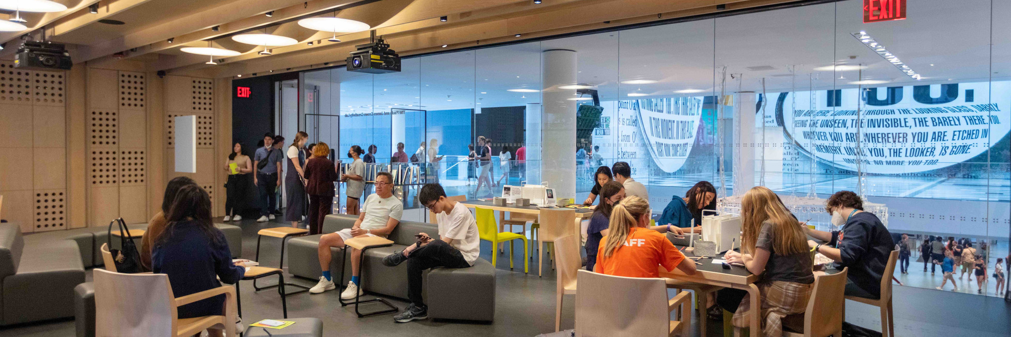 Photo of people sitting at tables in the Creativity Lab. The Museum of Modern Art, New York. Photo: Beatriz Meseguer/onwhitewalls.com. Digital image ©️ 2022 The Museum of Modern Art, New York