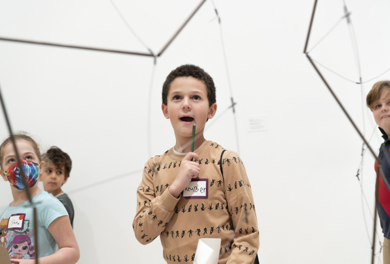 Child looking at a sculpture during a Family Gallery Talk. Photo: Martin Seck