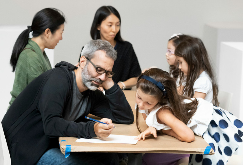 Families working together on a plan for their artwork. Photo: Martin Seck