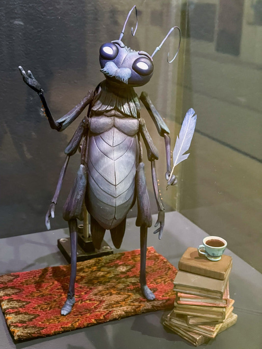 ShadowMachine. Cricket’s Quill &amp; Ink and Cricket’s Books. Oversized Cricket puppet by Mackinnon &amp; Saunders. On view in Guillermo del Toro: Crafting Pinocchio