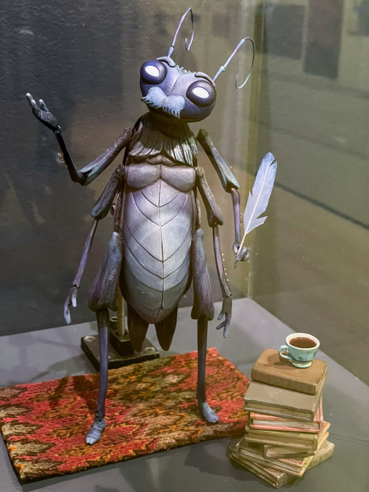 ShadowMachine. Cricket’s Quill & Ink and Cricket’s Books. Oversized Cricket puppet by Mackinnon & Saunders. On view in Guillermo del Toro: Crafting Pinocchio