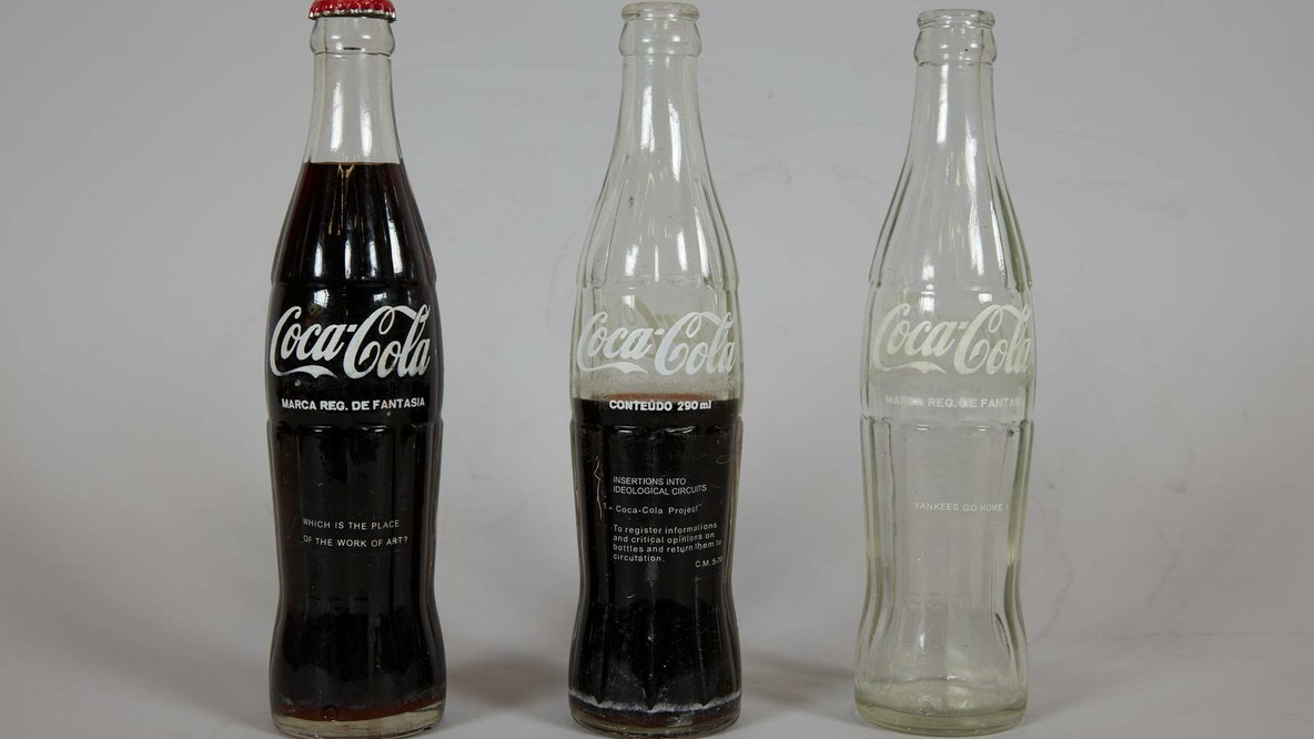 Cildo Meireles. INSERTIONS INTO IDEOLOGICAL CIRCUITS: 1. COCA-COLA PROJECT (INSERÇÕES EM CIRCUITOS IDEOLÓGICOS: 1. PROJETO COCA-COLA). 1970. Printed pressure-sensitive labels on three commercial glass bottles. Gift of Lilian Tone