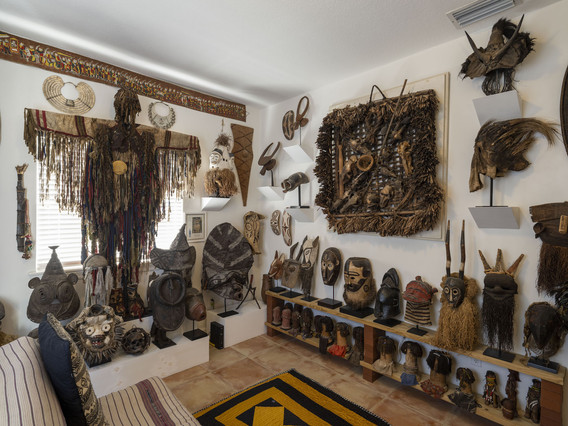 José Bedia’s collection in his Miami home. At left, a shaman dress from Mongolia