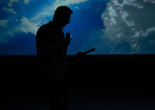 Lawrence Abu Hamdan performing Air Pressure, Künstlerhaus Mousonturm, Frankfurt. 2021. Courtesy of the artist. Photo: Christian Schuller