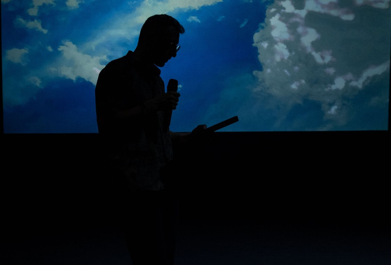 Lawrence Abu Hamdan performing Air Pressure, Künstlerhaus Mousonturm, Frankfurt. 2021. Courtesy of the artist. Photo: Christian Schuller