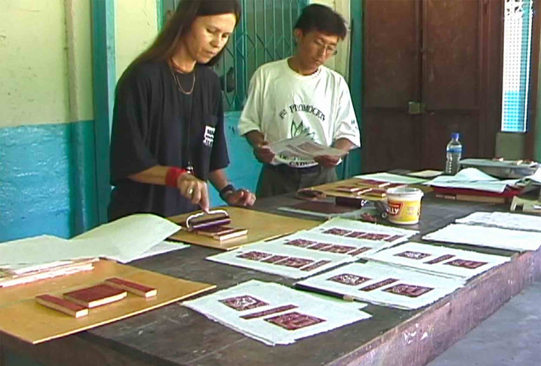 Still from the video Yanomami Owë Mamotima of Laura Anderson Barbata and Sheroanawe Hakihiiwe working on an edition of the book Shapono, Mahekototeri, Venezuela, 2001