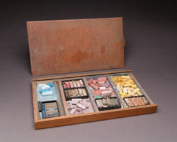 Selection of O’Keeffe’s materials, including charcoal and graphite sticks, conté crayons, pencils, pastels, watercolors, brushes, and boxes of drawing implements