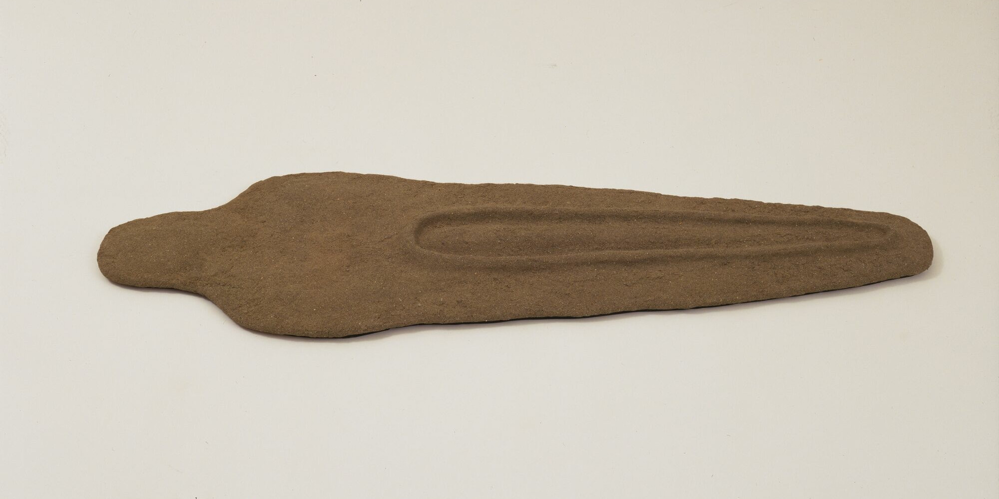 Ana Mendieta. Nile Born. 1984. Sand and binder on wood, 2 3/4 × 19 1/4 × 61 1/2&#34; (7 × 48.9 × 156.2 cm). The Museum of Modern Art, New York. Gift of Agnes Gund. © 2023 Estate of Ana Mendieta Collection