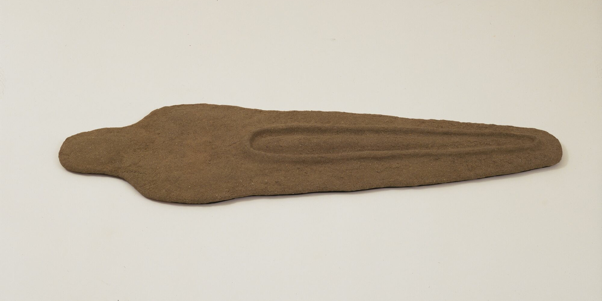 Ana Mendieta. Nile Born. 1984. Sand and binder on wood, 2 3/4 × 19 1/4 × 61 1/2" (7 × 48.9 × 156.2 cm). The Museum of Modern Art, New York. Gift of Agnes Gund. © 2023 Estate of Ana Mendieta Collection