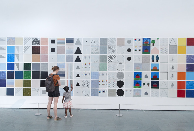 Photo: Jennifer Bartlett. Rhapsody (detail). 1975–76. Enamel on steel, 987 plates. The Museum of Modern Art, New York. Gift of Edward R. Broida. © 2023 Jennifer Bartlett. Photographer: Gus Powell Image description: A family points at lines, shapes, and colors they see in the painting Rhapsody, by Jennifer Bartlett.