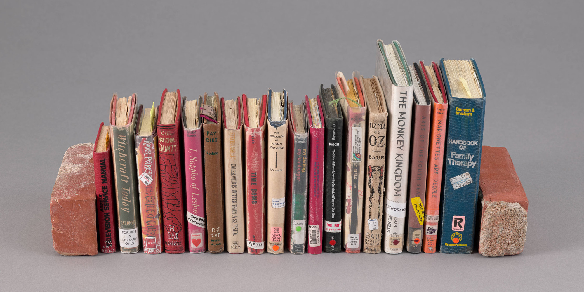 Charles LeDray. Book Ends. 2018–20. Eighteen handbound miniature books with letterpress, inkjet, offset, pencil, crayon, and ink on paper and two clay bricks, part (bookends, each): 3 3/4 × 1 5/8 × 1 1/8" (9.5 × 4.1 × 2.9 cm). Printer: Leslie Miller, The Grenfell Press, New York. Fabricator: Mark Tomlinson (Bookbinder). Edition: Unique. The Museum of Modern Art, New York. Gift of Library Council of The Museum of Modern Art
