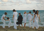 Les plages d’Agnès (The Beaches of Agnès). 2008. France. Written and directed by Agnès Varda. Courtesy of Cinema Guild/Photofest. ©️ Cinema Guild Image description: A group of seven individuals dressed in white are dancing on the beach. The central figure dressed in black, filmmaker Agnès Varda, smiles as she looks at the others engaging in movement and embracing one another.