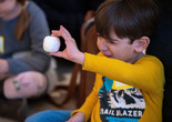 The family program A Closer Look for Kids: How’d They Make That? Materials and Process. Photo: Manuel Martagon Image description: A participant exploring model magic during a Family Gallery Talk
