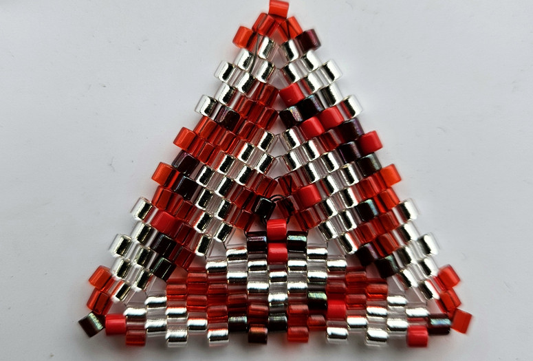 Image courtesy of the artist Image description: a beaded triangle