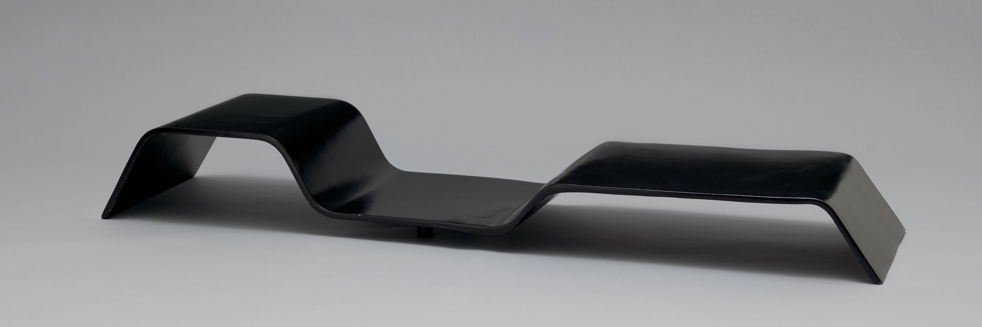 Oscar Niemeyer. “Modulo” Low Table. 1978. Painted plywood and steel, 9 1/2 × 75 3/4 × 19 3/4&#34; (24.1 × 192.4 × 50.2 cm). The Museum of Modern Art, New York. Committee on Architecture and Design Funds