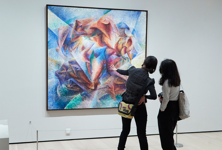Two visitors look at art in MoMA’s galleries. Photo: Gus Powell. Shown: Umberto Boccioni. Dynamism of a Soccer Player. 1913. Oil on canvas, 6&#39; 4 1/8&#34; × 6&#39; 7 1/8&#34; (193.2 × 201 cm). The Museum of Modern Art, New York. The Sidney and Harriet Janis Collection