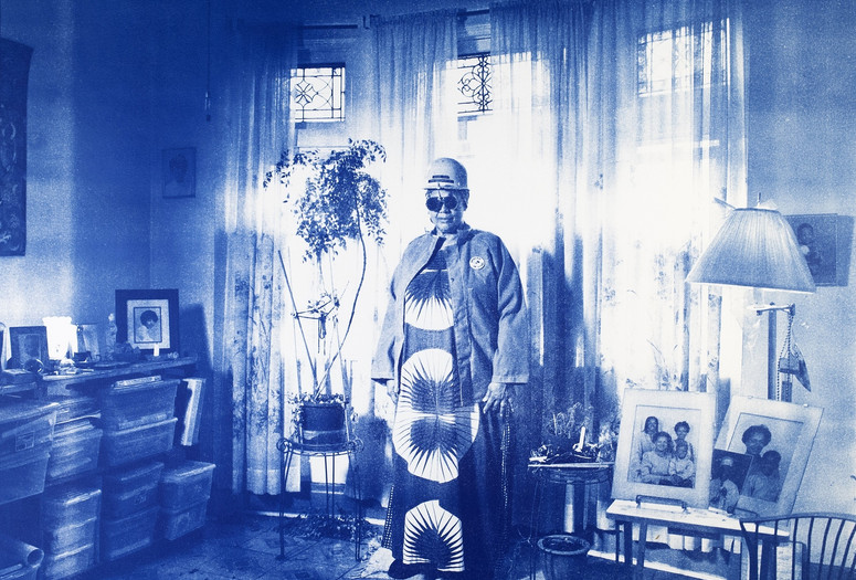 LaToya Ruby Frazier. Sandra Gould Ford Wearing Her Work Jacket and Hard Hat in Her Meditation Room in Homewood, PA from On the Making of Steel Genesis: Sandra Gould Ford, 2017. © 2024 LaToya Ruby Frazier. Courtesy of the artist and Gladstone gallery