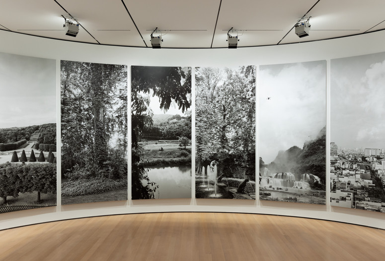 Installation view of An-My Lê: Between Two Rivers/Giữa hai giòng sông/Entre deux rivières, The Museum of Modern Art, New York, November 5, 2023–March 9, 2024. Photo: Jonathan Dorado. Digital image © 2024 The Museum of Modern Art, New York. Shown: An-My Lê. Fourteen Views. 2023. Fourteen wallpaper and wood panels, approx. 10′ × 34′ × 7′ (304.8 × 1036.3 × 213.4 cm). The Museum of Modern Art, New York. Acquired with the support of the Contemporary Arts Council of The Museum of Modern Art, and the Carol and David Appel Family Fund in honor of Roxana Marcoci. © 2024 An-My Lê