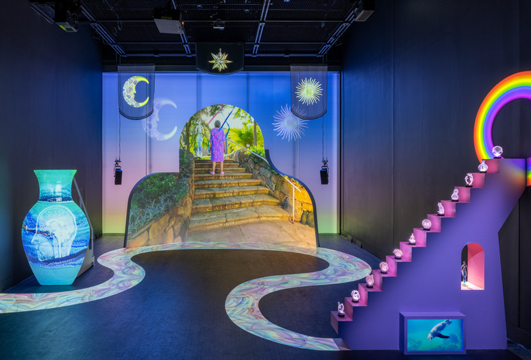 Shana Moulton. Meta/Physical Therapy. 2023–24. Eight-channel 4K and high-definition video (color, sound; 14:49 min.), MDF, vinyl, seating, scrims, props, and window gel, dimensions variable. Courtesy the artist, Galerie Crèvecœur, and Galerie Gregor Staiger. ©️ 2024 Shana Moulton. Installation view, The Museum of Modern Art, New York, February 17–April 21, 2024. Photo: Jonathan Dorado