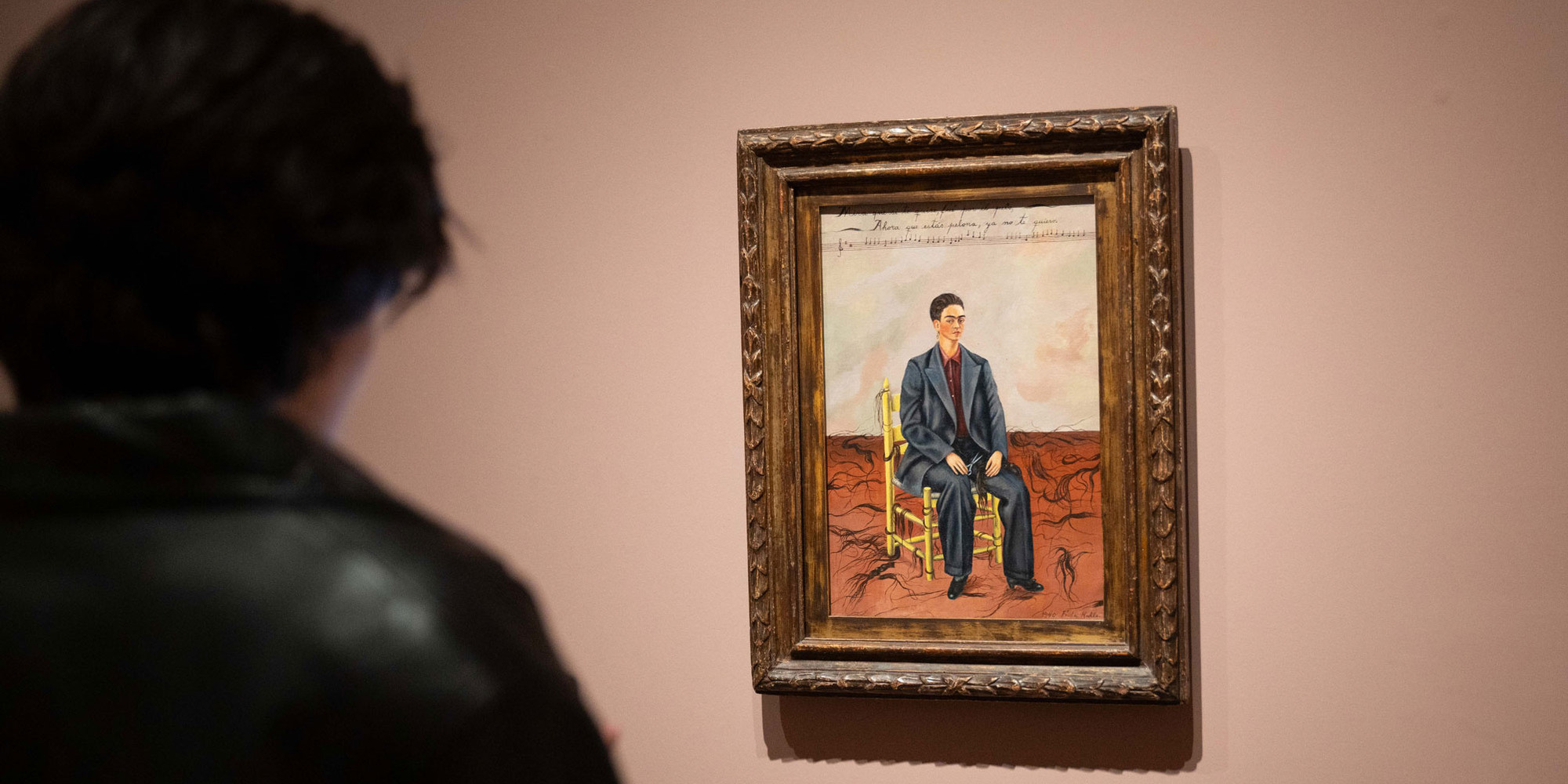 Iris Olympia at MoMA, 2024. Photo: Naeem Douglas. Shown: Frida Kahlo. Self-Portrait with Cropped Hair. 1940. Oil on canvas, 15 3/4 × 11" (40 × 27.9 cm). The Museum of Modern Art, New York. Gift of Edgar Kaufmann, Jr. © 2024 Banco de México Diego Rivera Frida Kahlo Museums Trust, Mexico, D.F./Artists Rights Society (ARS), New York