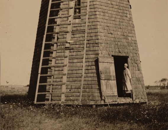 Agnes Pelton standing outside her windmill studio, 1921