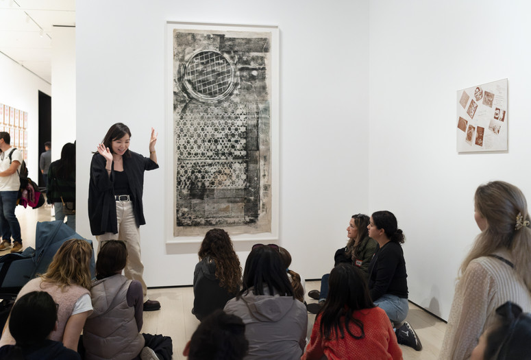 Photo: Martin Seck Image description: Families look at Soho Sidewalk by Sari Dienes during a Family Gallery Talk
