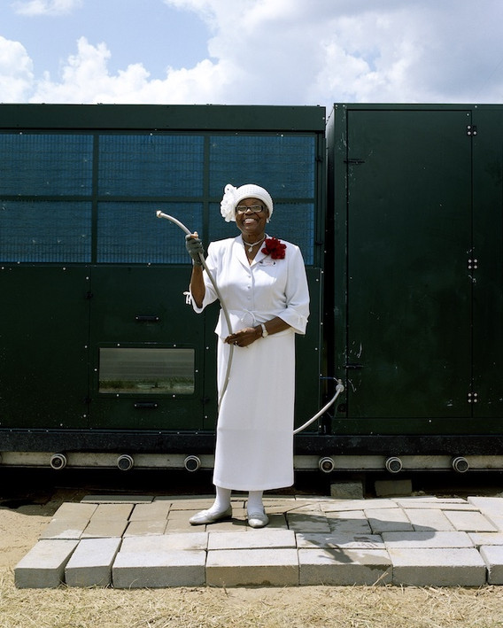 LaToya Ruby Frazier. Mary A. Williams, Tuklor’s Mother, Holding the Water Hose at the Atmospheric Water Generator on North Saginaw Street Between East Marengo Avenue and East Pulaski Avenue, Flint, Michigan from Flint Is Family in Three Acts. 2019–20
