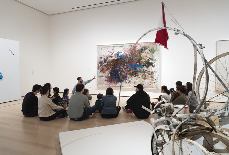 Families looking at a painting during a Family Gallery Talk. Photo: Martin Seck