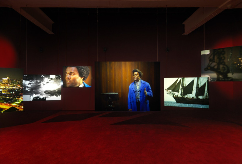 Isaac Julien. Lessons of the Hour. 2019. Ten-channel 4K video and 35mm film transferred to high-definition video (color, sound; 28:46 min.) and 10 projection screens, dimensions variable. The Museum of Modern Art, New York. Acquired through the generosity of the Ford Foundation. © 2024 Isaac Julien. Installation view, Metro Pictures, New York, 2019