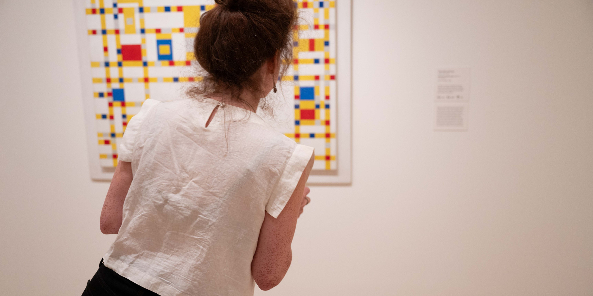 Caroline Schiff at MoMA. Photo: Naeem Douglas. Shown: Piet Mondrian. Broadway Boogie Woogie. 1942–43. Oil on canvas, 50 × 50" (127 × 127 cm). The Museum of Modern Art, New York. Given anonymously