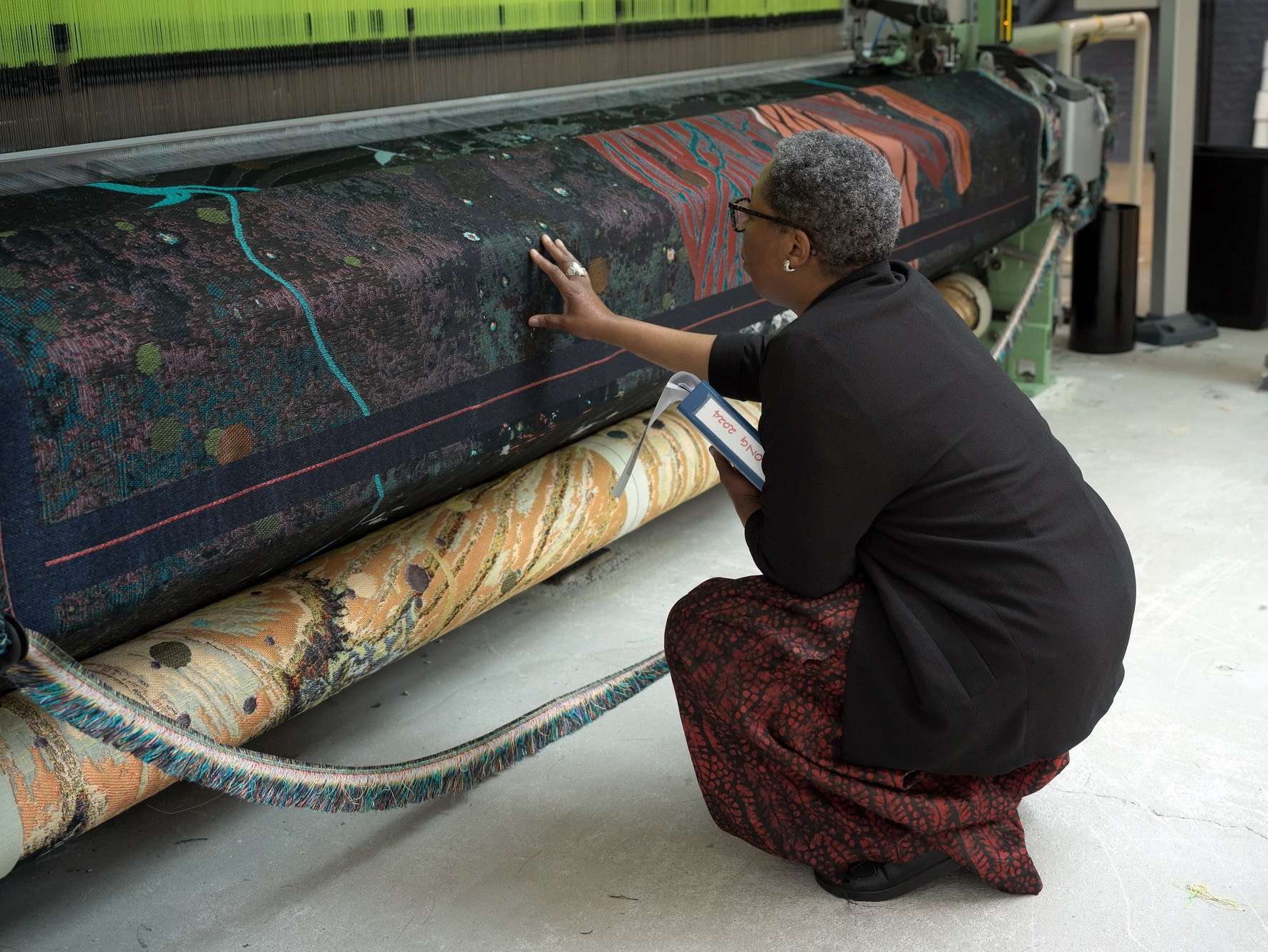 Otobong Nkanga with textile in progress for *Otobong Nkanga: Cadence*. Courtesy of the artist © Otobong Nkanga. Photo: Wim van Dongen