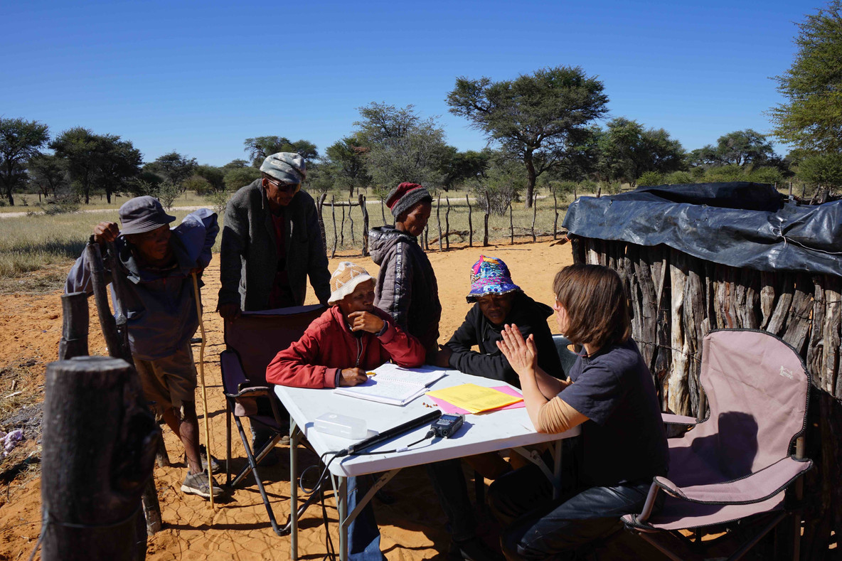 Translation process in Corridor 17, Namibia. Franco (left) and Klosi (right) are seated at the table with Mobarak