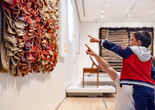 Photo: On White Wall Inc.Image description: A child and a caregiver point up at an artwork on the gallery wall.
